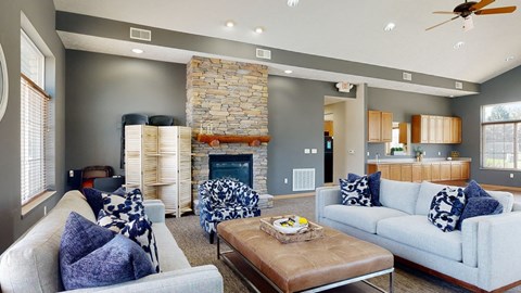 clubhouse living room with couches and a coffee table in front of a fireplace