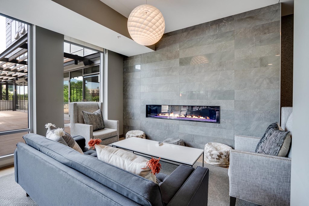 Relax on the couches by the fireplace in the Club Room at The Preserve at Normandale Lake