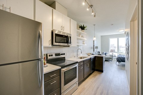 a kitchen with stainless steel appliances and white cabinets