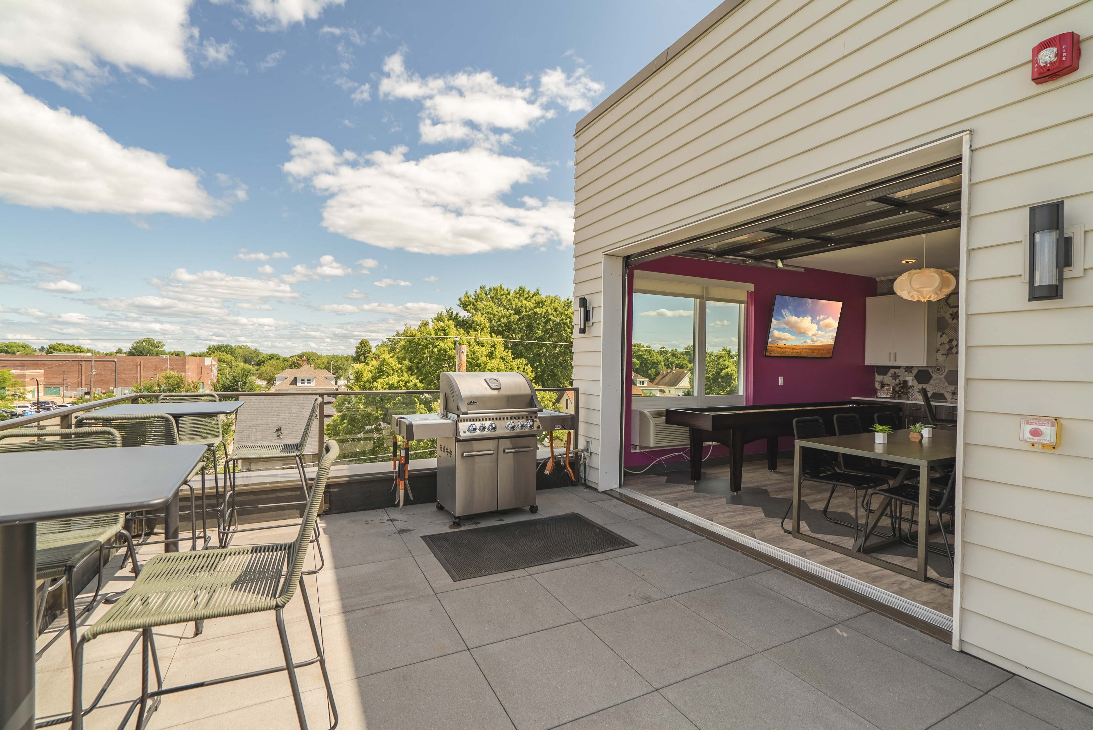 Rooftop community room opens to the patio and deck at The Central apartments near downtown Minneapolis MN 55408