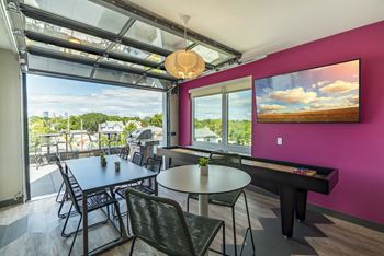 Rooftop community room with seating and TV at The Central apartments near downtown Minneapolis MN 55408