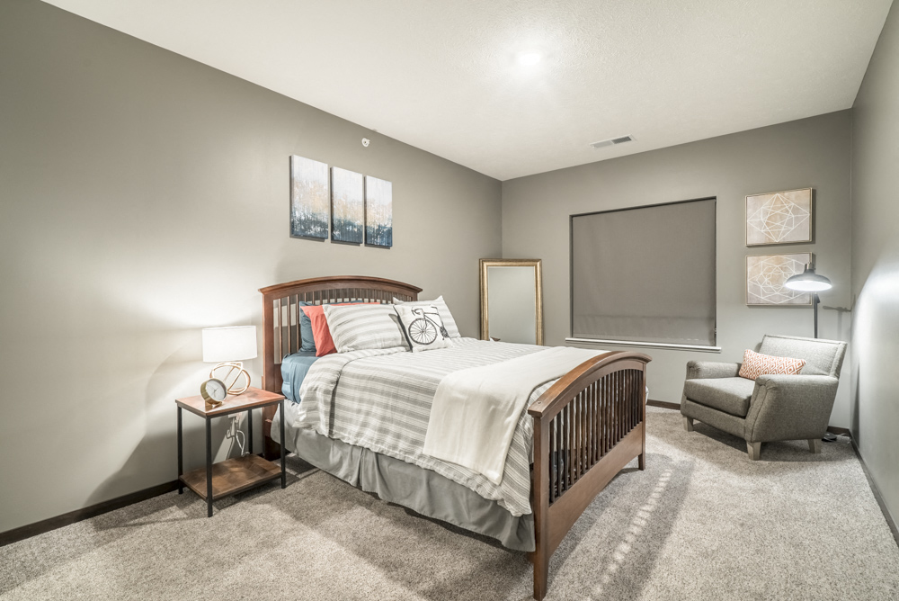 1-bedroom apartment with king-size bed and walk-in closet at The Conrad in Blackstone District Omaha