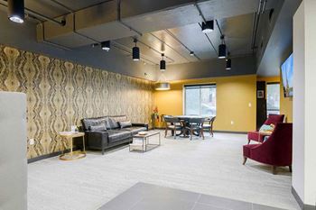 a spacious pub room with lounge style seating, couches, and tables