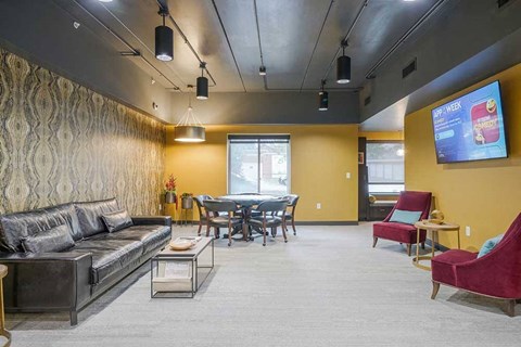 a spacious lounge/pub room with couch and table seating and a tv