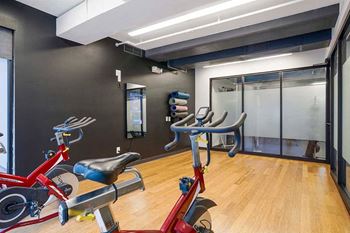 a yoga and spin studio featuring an Echelon mirror with on demand fitness courses