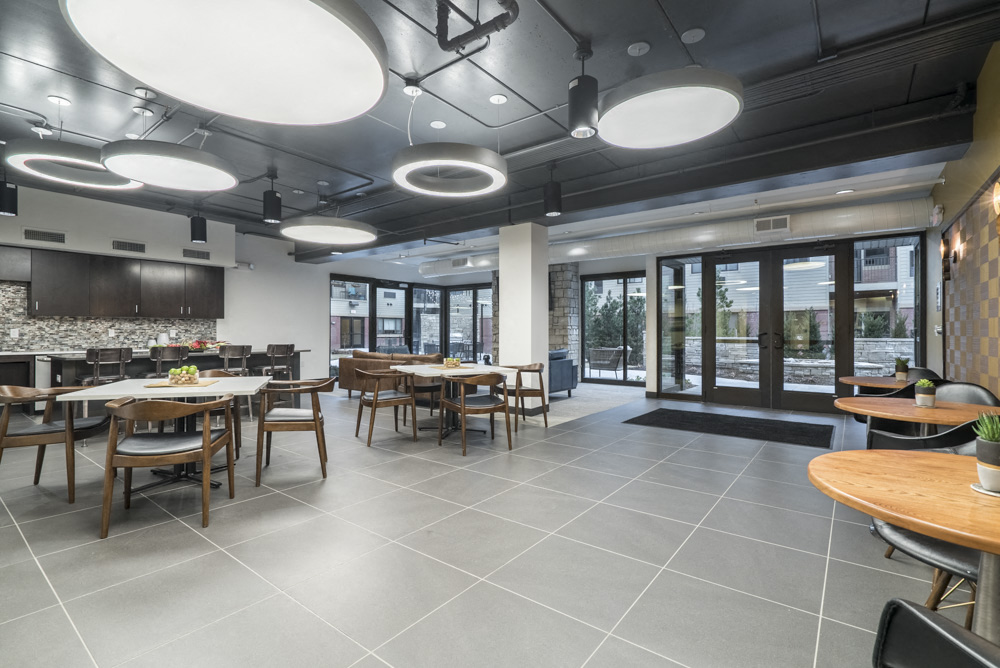 Clubhouse interior with kitchen and seating at The Conrad apartments in Omaha NE