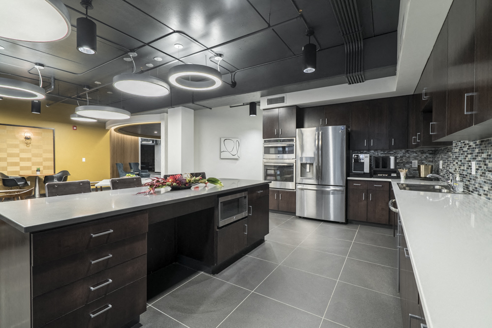 Clubhouse interior with kitchen and seating at The Conrad in Omaha NE