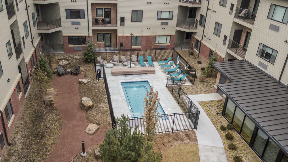 The Conrad courtyard with park, cocktail pool and spa, grills and walking path in Omaha NE