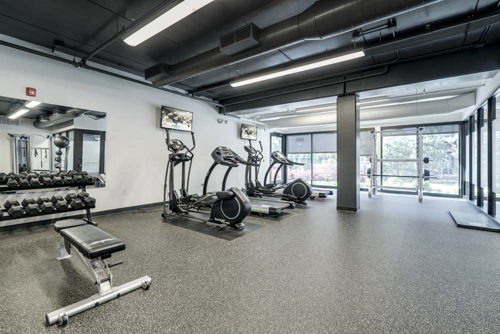 Fitness center with cardio and free weights at The Conrad near UNMC in the Blackstone District Omaha NE 68105
