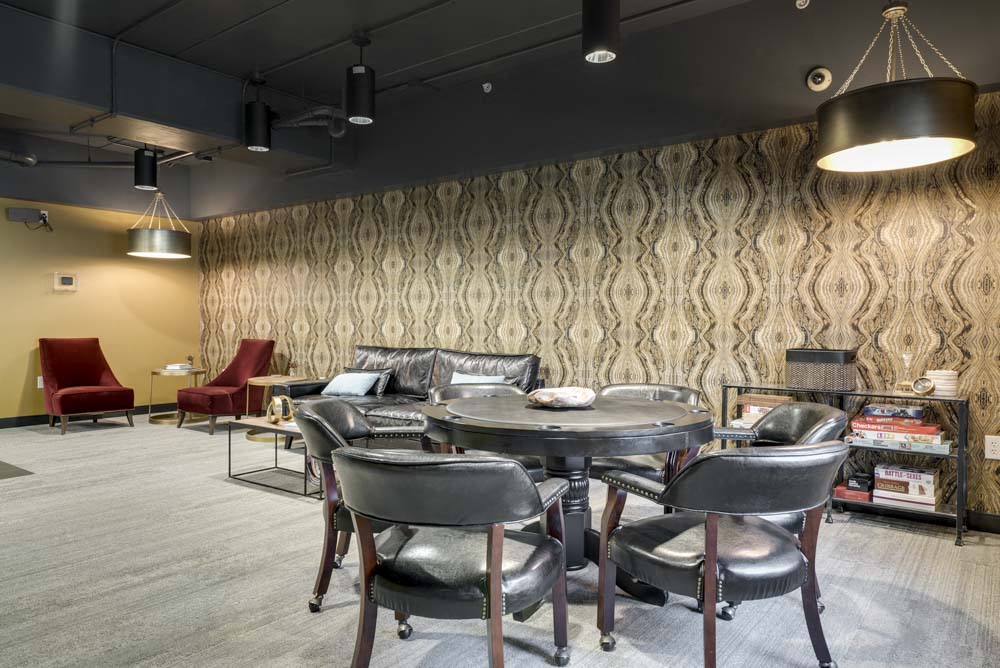 Pub room with lounge chairs and games at The Conrad near UNMC in the Blackstone District Omaha NE 68105