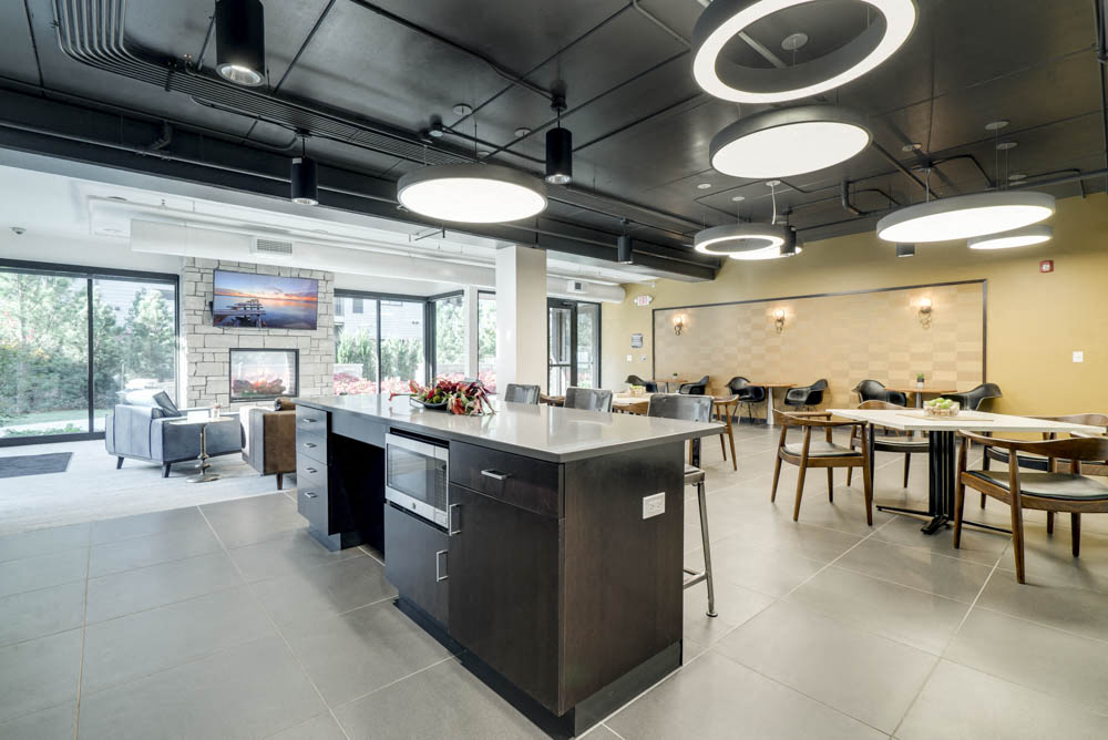 Kitchen with TV lounge and seating at The Conrad near UNMC in the Blackstone District Omaha NE 68105