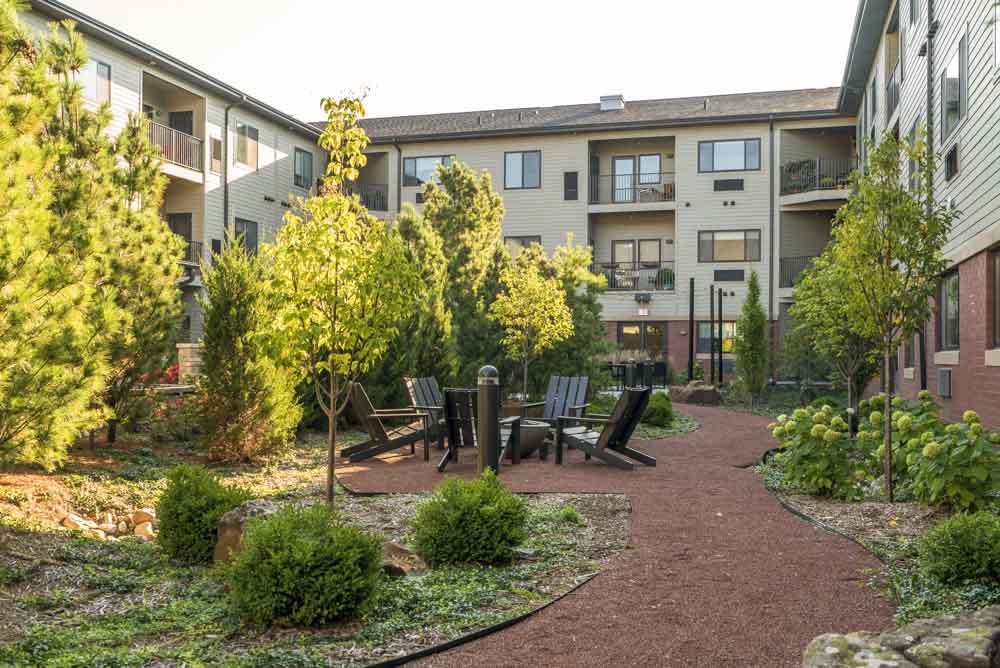 Ample greenery and trees in the pocket park at The Conrad near UNMC in the Blackstone District Omaha NE 68105