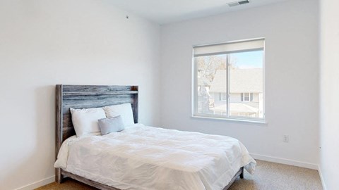 Furnished apartment bedroom with large single window