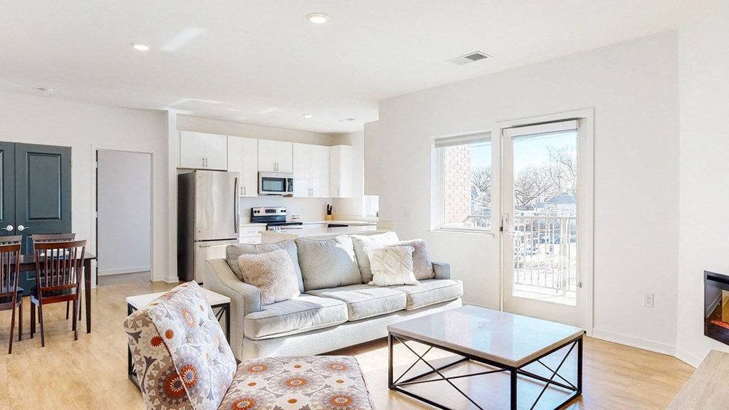 Furnished apartment living room with sofa, lounging chair, and coffee table