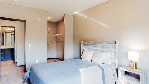 Furnished apartment bedroom with large walk in closet and easy bathroom access