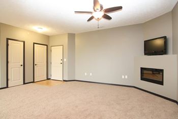 A living room with a fireplace and a television.