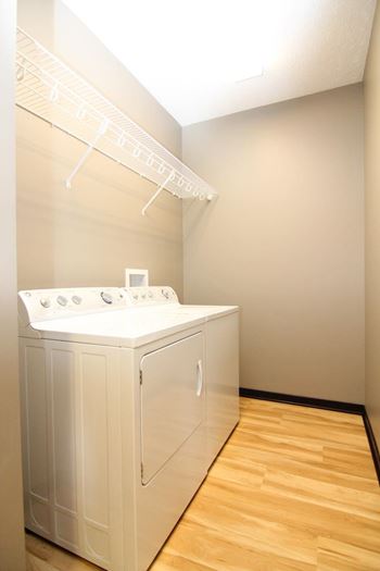 A white washing machine and dryer in a laundry room.
