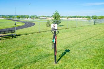 community dog park leash holder with black bench in the background