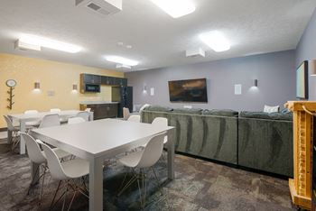 theater room with a table, chairs and a couch