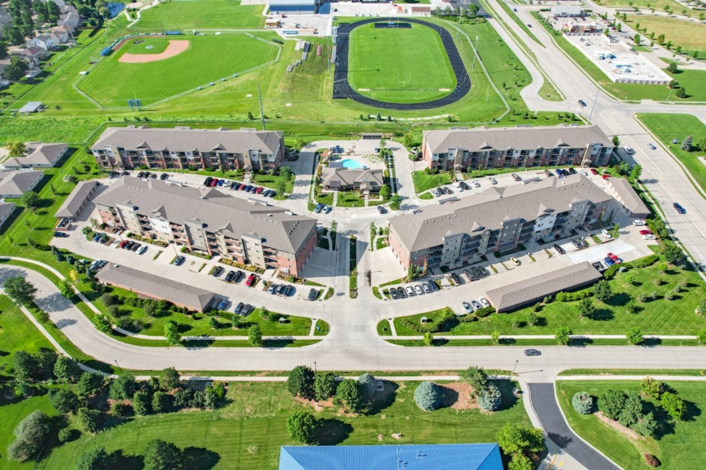 arial view of The Flats at 84 with green grass and a track in the background