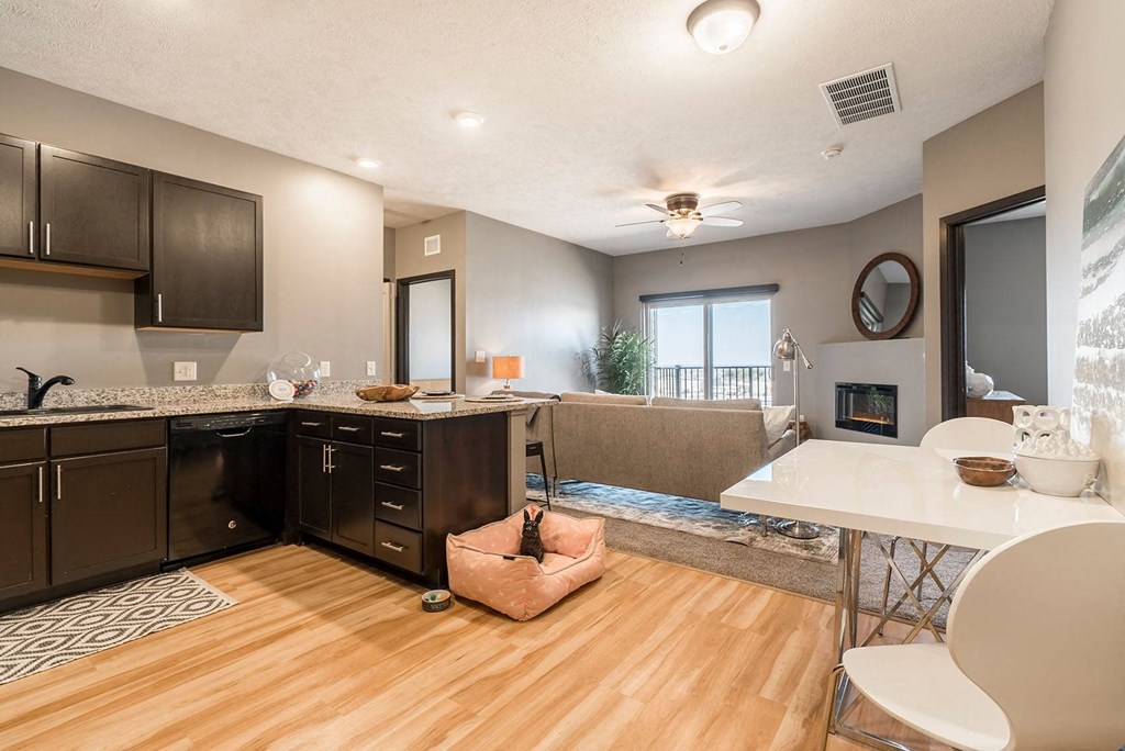 an open kitchen and living room with a fireplace and a table