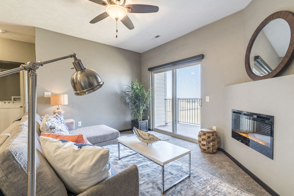 a living room with a couch and a ceiling fan