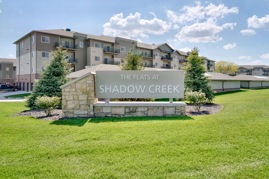 Exterior of apartment building and sign reading