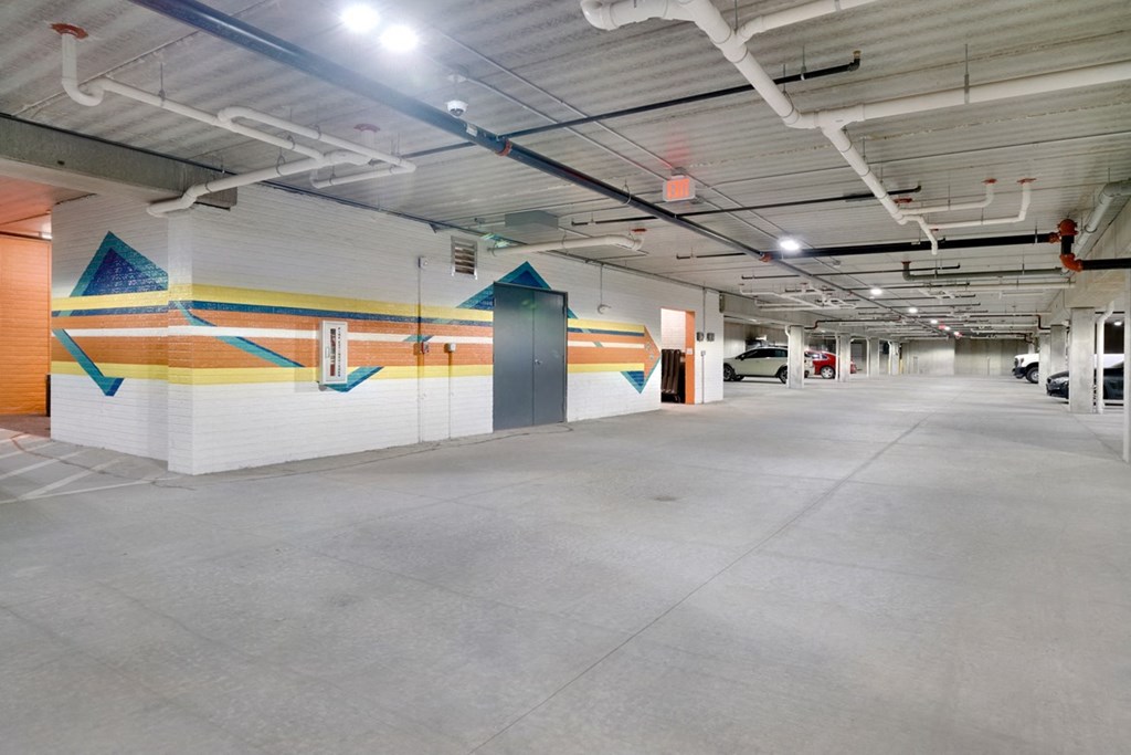 Underground parking garage with colorful mural painted on two interior walls