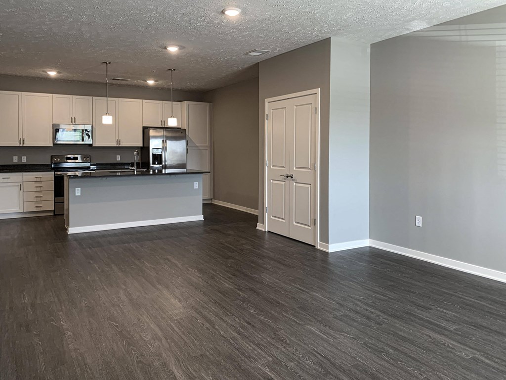 Living and dining area leading into the kitchen in the buffalo floorplan at the flats at shadow creek