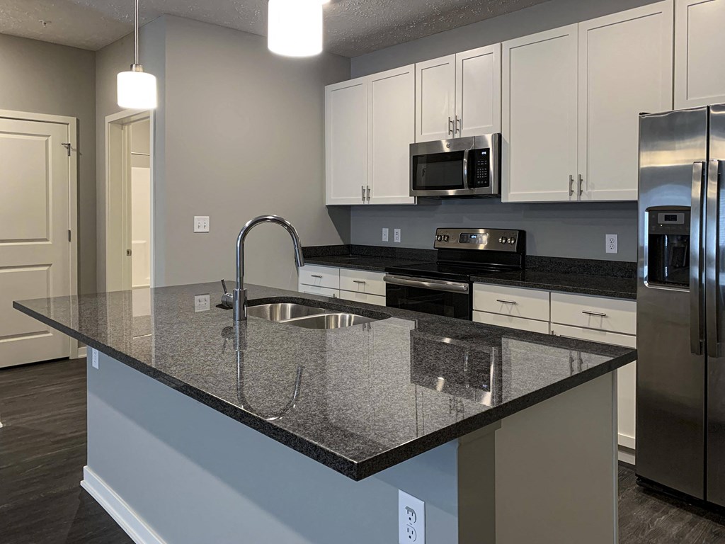 Large kitchen island with granite countertops and sink