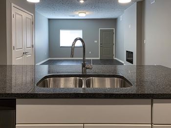 Large kitchen island with granite countertops and sink