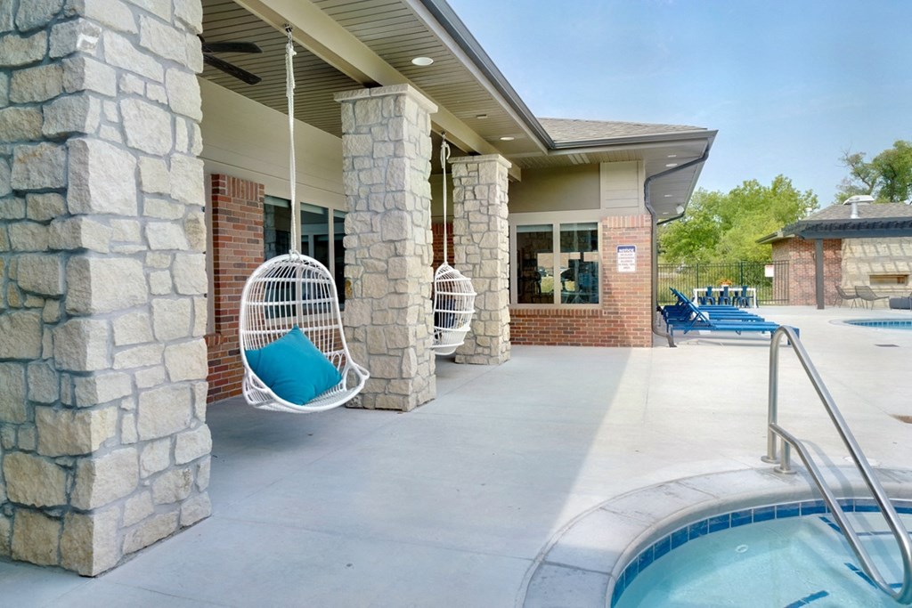 Hanging bubble chairs outside of the clubhouse near the pool and hot tub at Flats at Shadow Creek