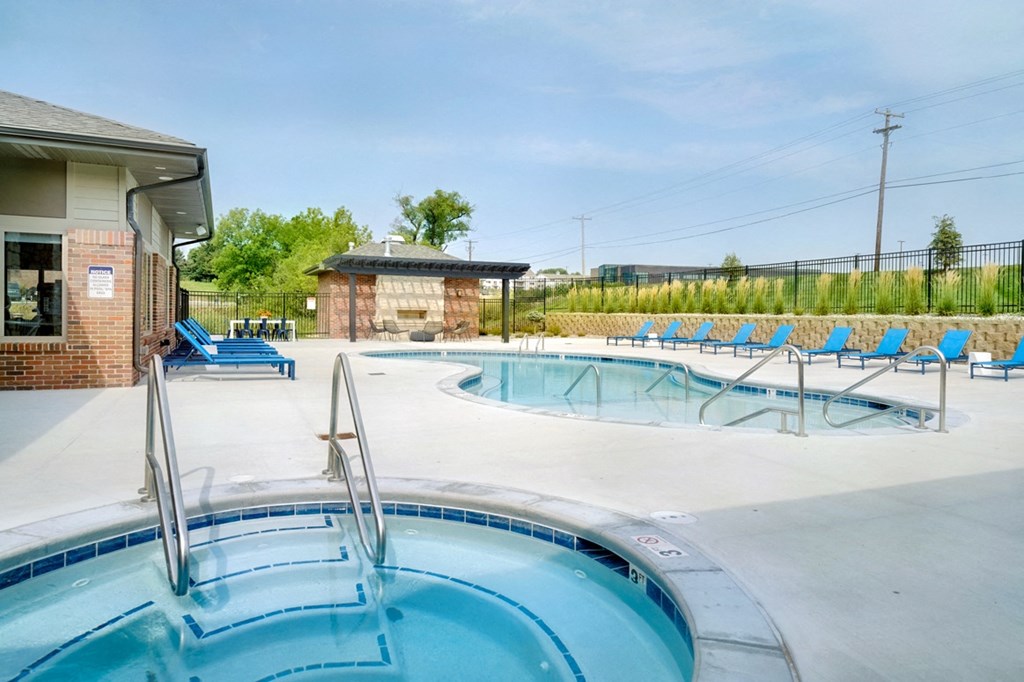 Resort style pool with lounge chairs outside the clubhouse at The Flats at Shadow Creek