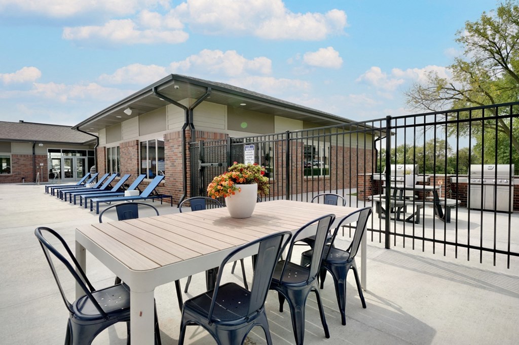 Outdoor dining table on the pool deck at The Flats at Shadow Creek
