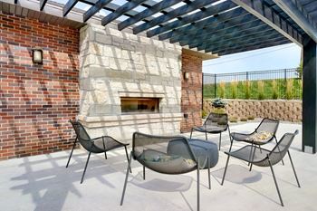 Outdoor brick fireplace with chairs positioned around it