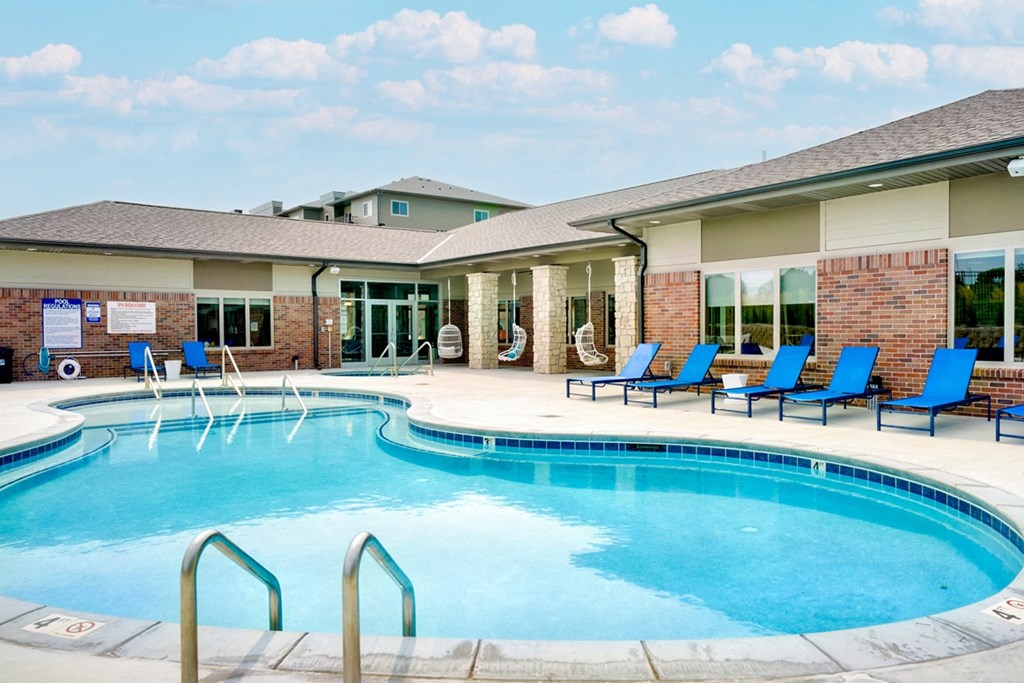 Resort style pool with lounge chairs outside the clubhouse at The Flats at Shadow Creek