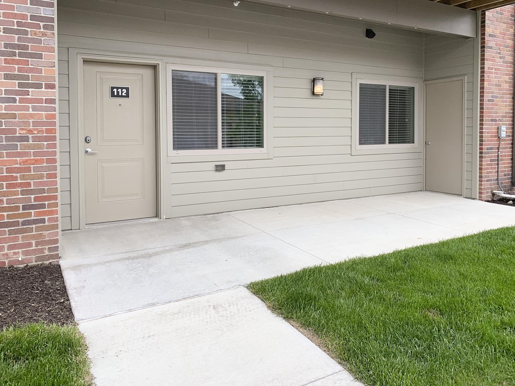 Outdoor patio area and entrance to apartment The Flats at Shadow Creek in Lincoln Nebraska