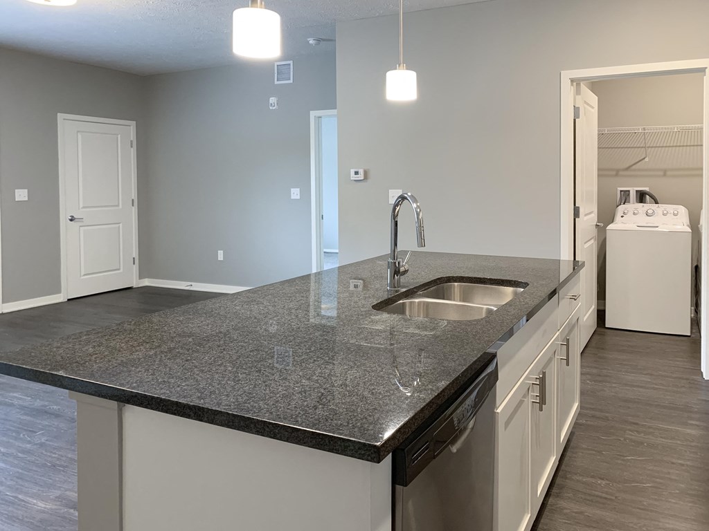 large dark granite countertop island with view of dining room The Flats at Shadow Creek in Lincoln Nebraska