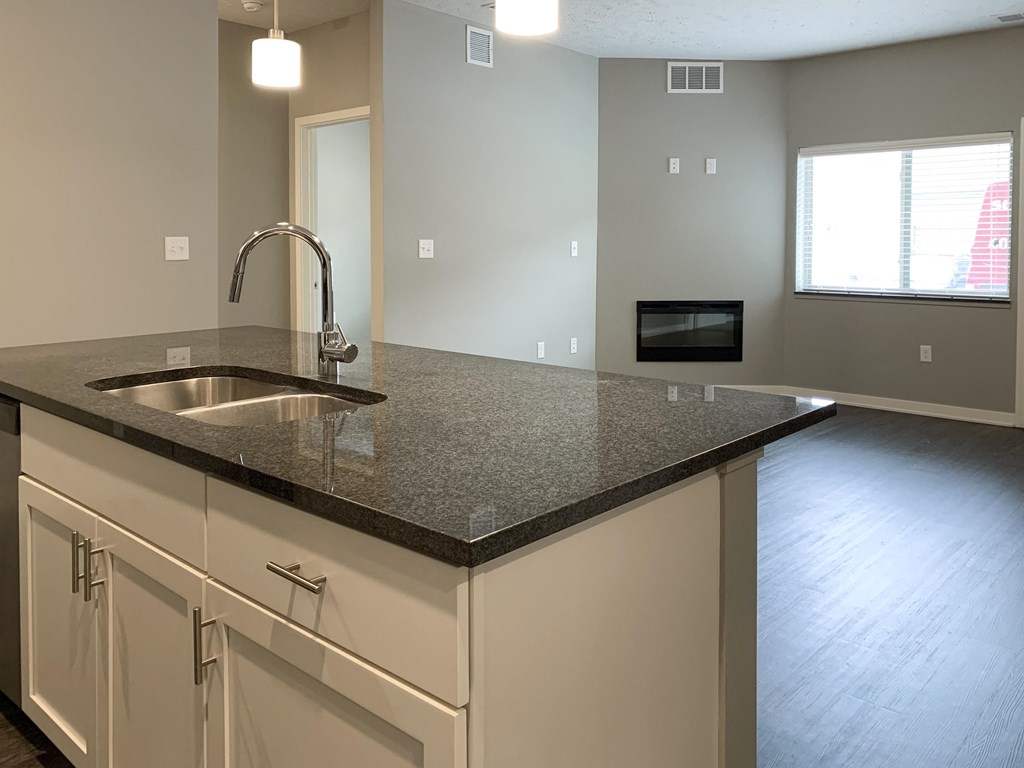 large dark granite countertop island with view of dining room The Flats at Shadow Creek in Lincoln Nebraska