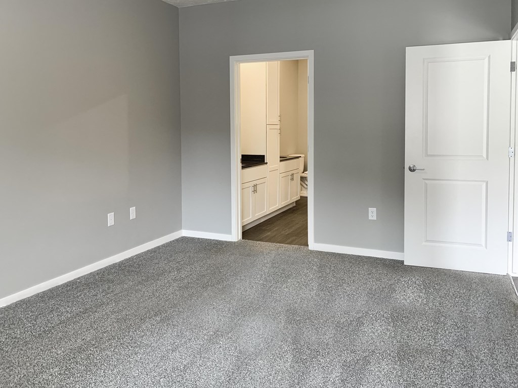master bedroom with access to walk in closet and private bathroom The Flats at Shadow Creek in Lincoln Nebraska