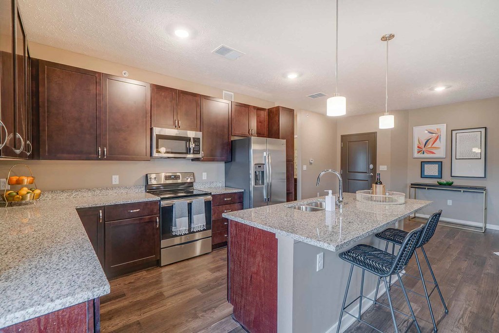 a kitchen with granite counter tops and stainless steel appliances