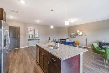 View of kitchen island and living room at The Flats at Shadow Creek