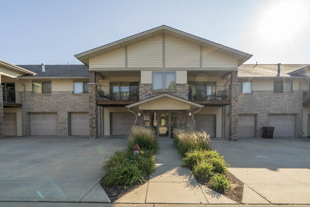 Exterior view of townhome-style villas with attached garages.