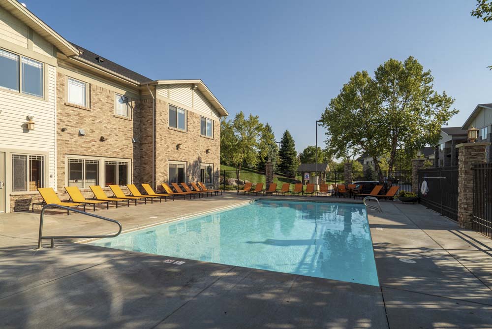 Swimming pool with seating  at Grand Legacy apartments and townhomes in west Omaha NE 68130