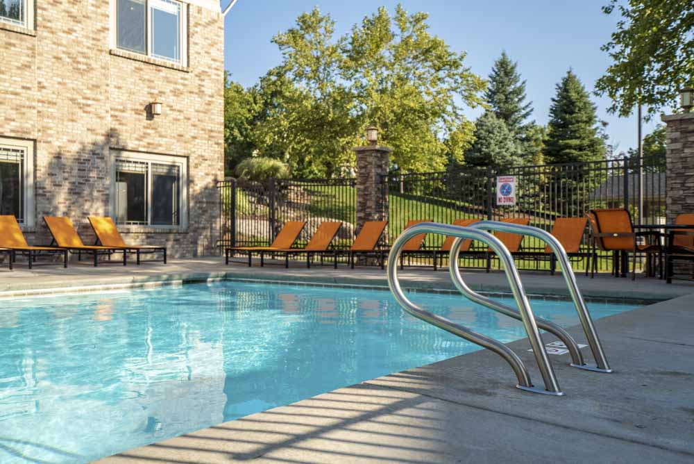 Swimming pool with poolside seating  at Grand Legacy apartments and townhomes in west Omaha NE 68130