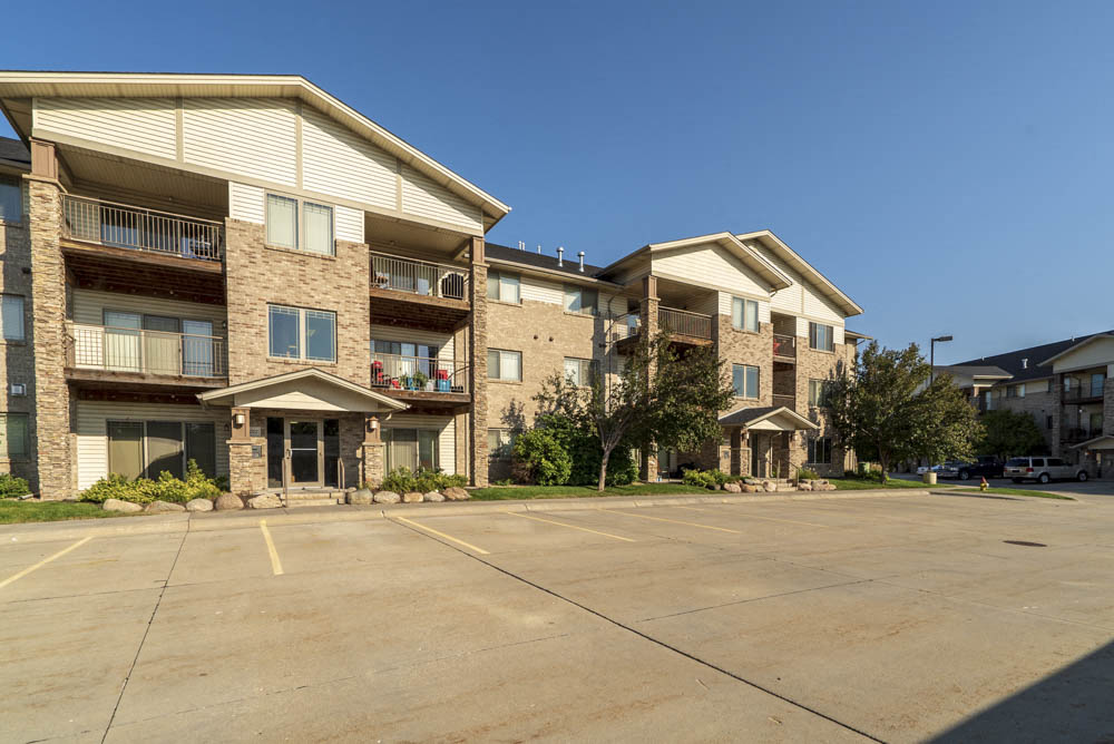 Flats-style building with balconies at Grand Legacy apartments and townhomes in west Omaha NE 68130