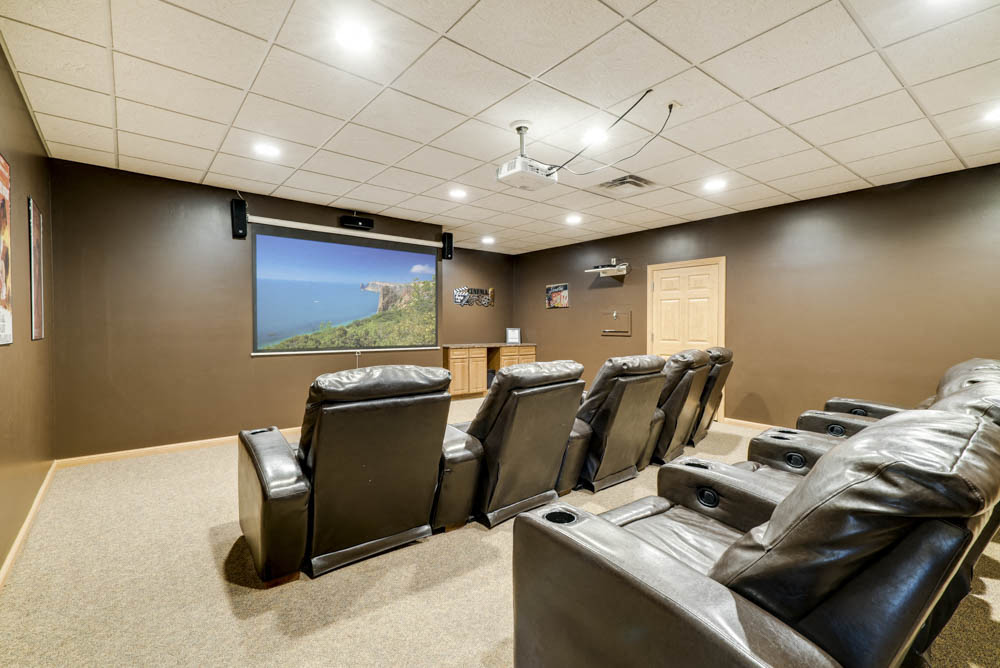 Theater room with comfy chairs and large screen  at Grand Legacy apartments and townhomes in west Omaha NE 68130