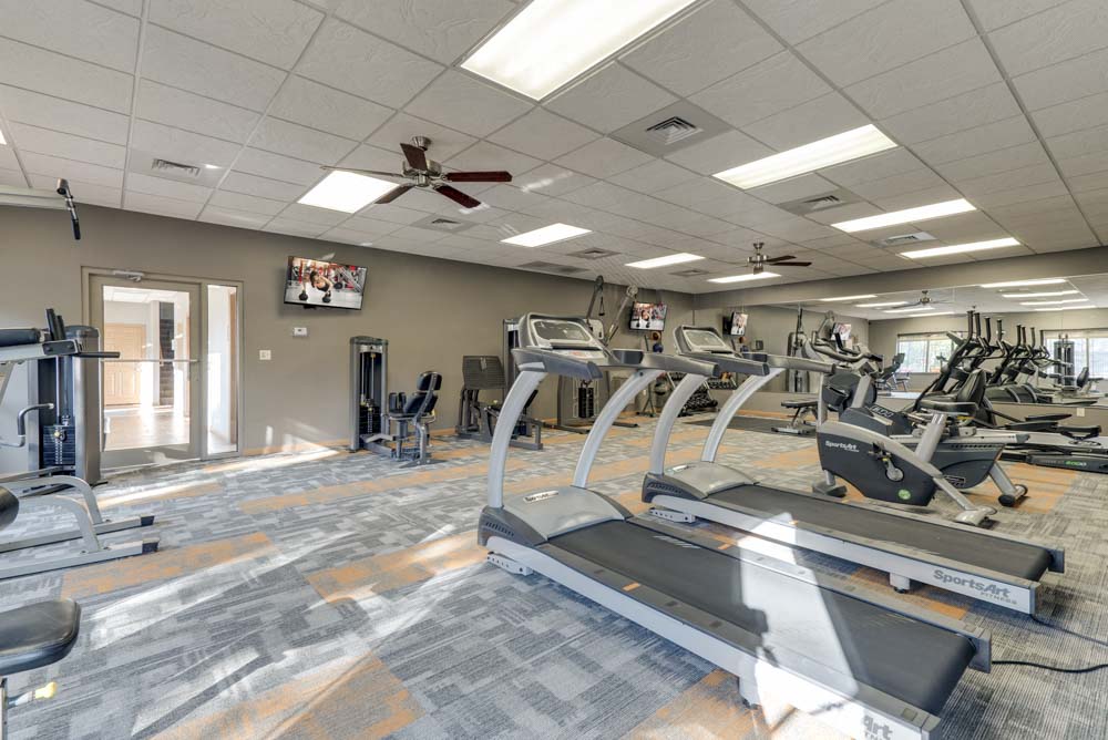 Large 24-hour fitness center with treadmills and weightlifting machines  at Grand Legacy apartments and townhomes in west Omaha NE 68130