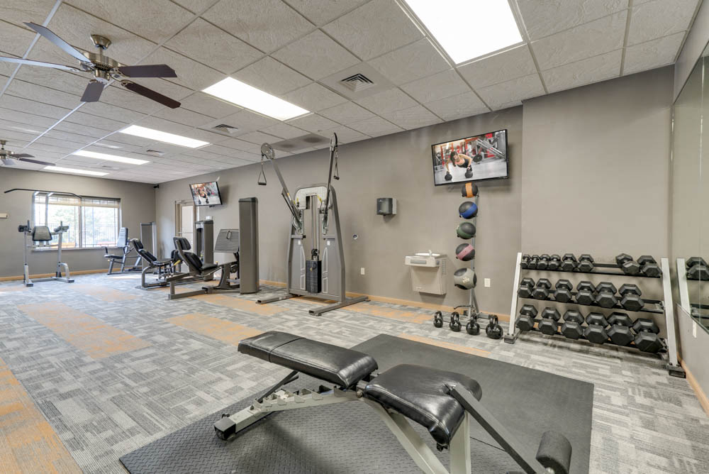 24-hour fitness center with free weights, TV and weightlifting machines  at Grand Legacy apartments and townhomes in west Omaha NE 68130