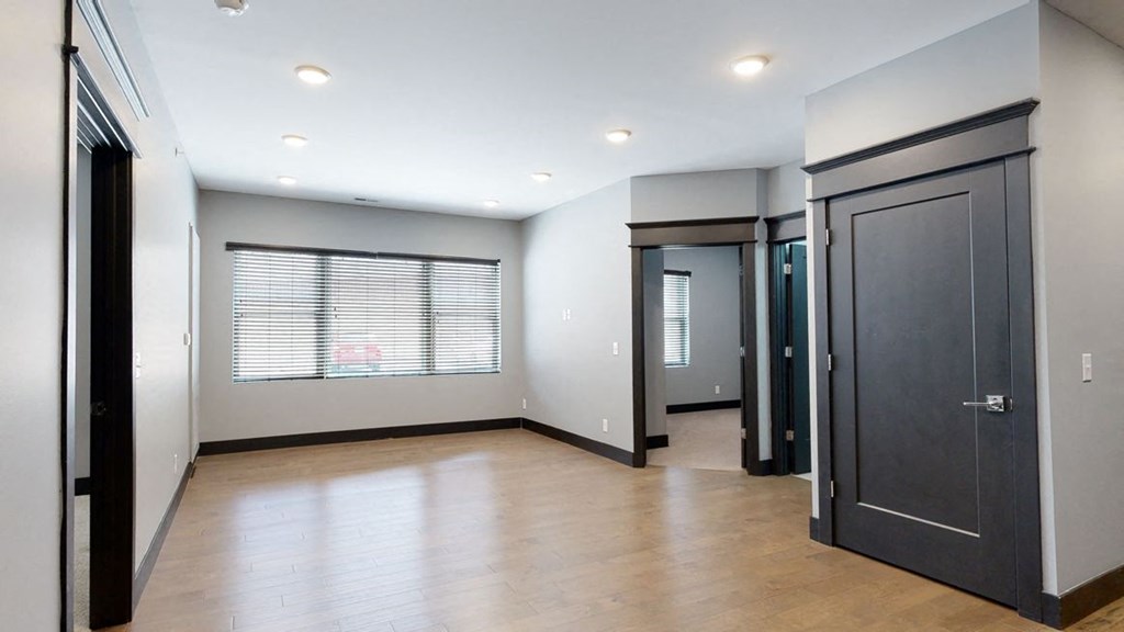 dining and living room space with light gray walls and a large window